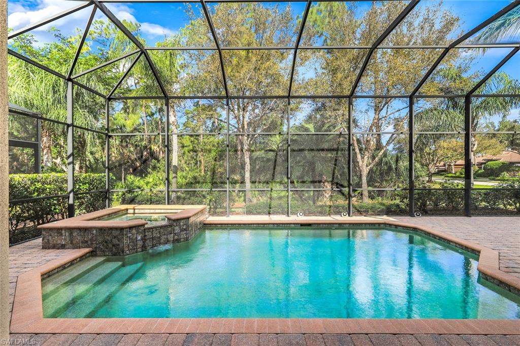 Combined pool / hot tub featuring a sunroom and a lanai
