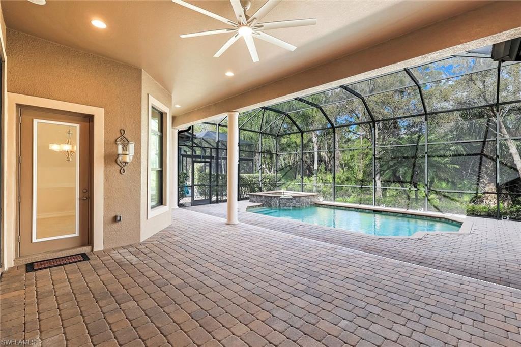Integrated pool / hot tub with a sunroom, a patio area, and a lanai