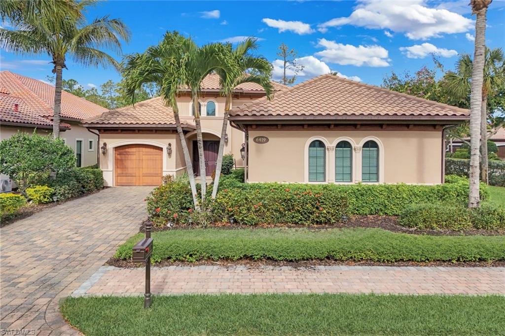 Mediterranean / spanish-style home with stucco siding, a garage, decorative driveway, and a tiled roof