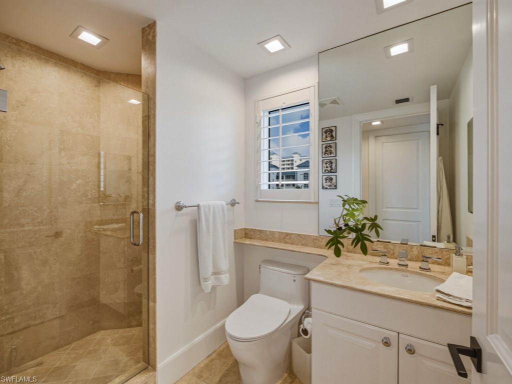 Bathroom featuring a stall shower and vanity