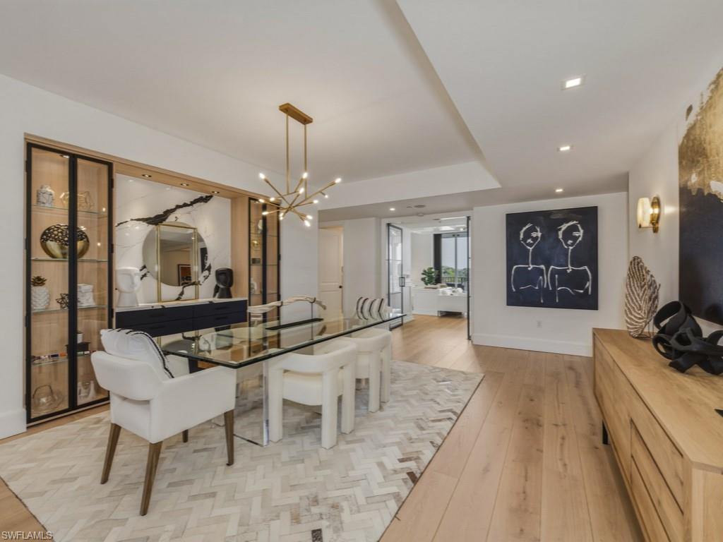 Dining area with light Oak floors and hanging lights