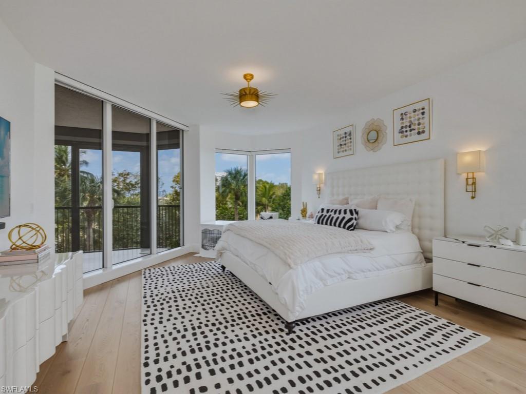 Bedroom featuring light wood finished floors and access to exterior