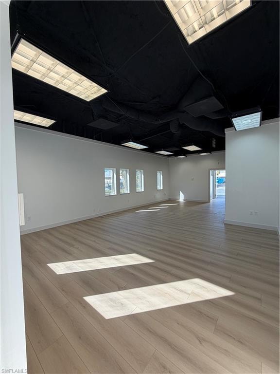 Unfurnished room featuring light wood-style floors and baseboards