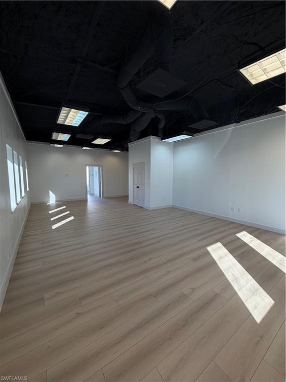 Basement featuring light wood-style floors and ornamental molding