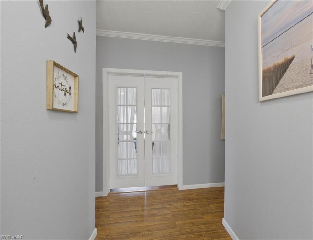 Front entrance foyer. French doors to den