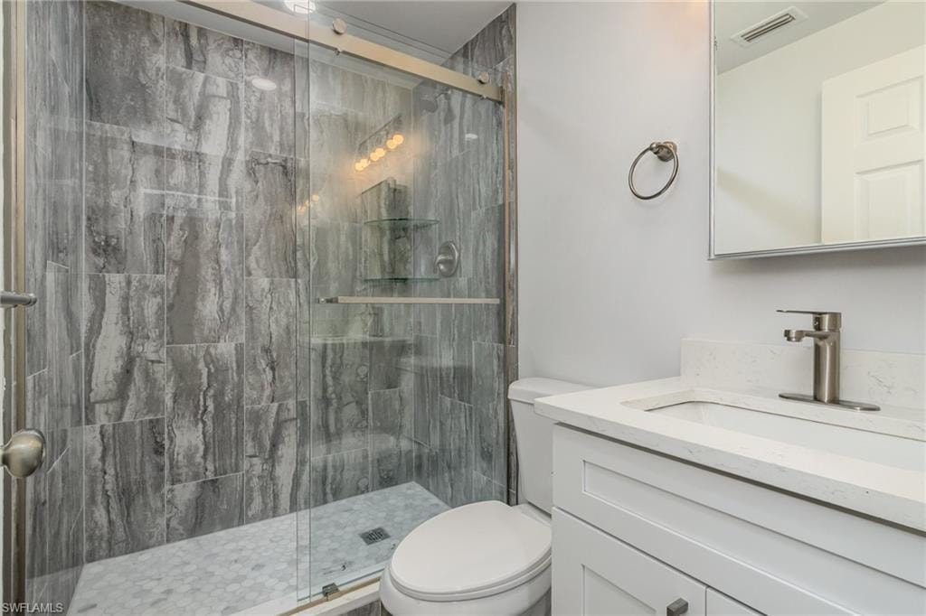 Full bathroom with vanity and a stall shower