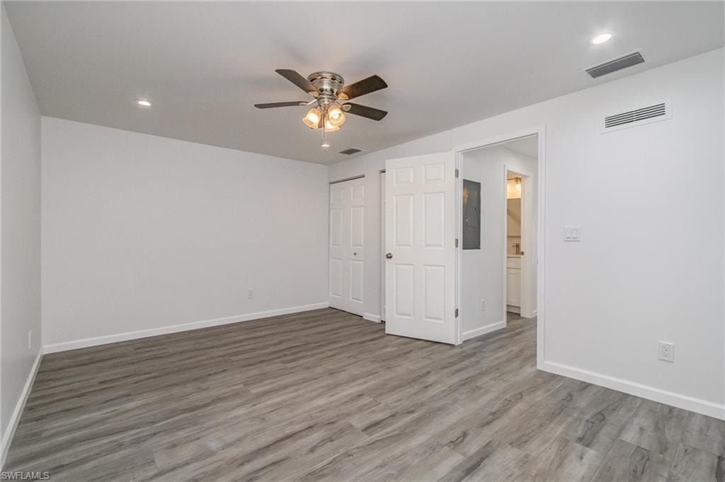 Unfurnished bedroom featuring ceiling fan, recessed lighting, light wood-style flooring, a closet, and electric panel