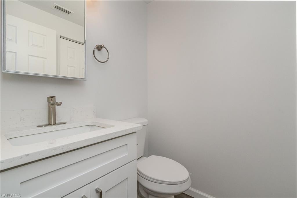 Half bath with vanity and toilet