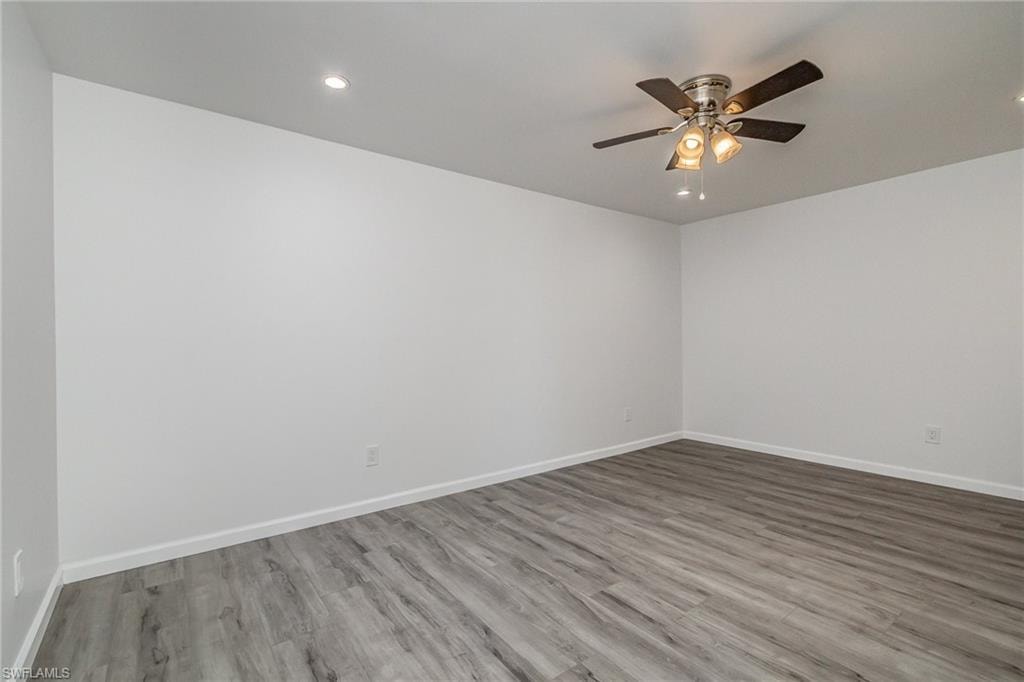 Spare room featuring light wood-style flooring, ceiling fan, and recessed lighting