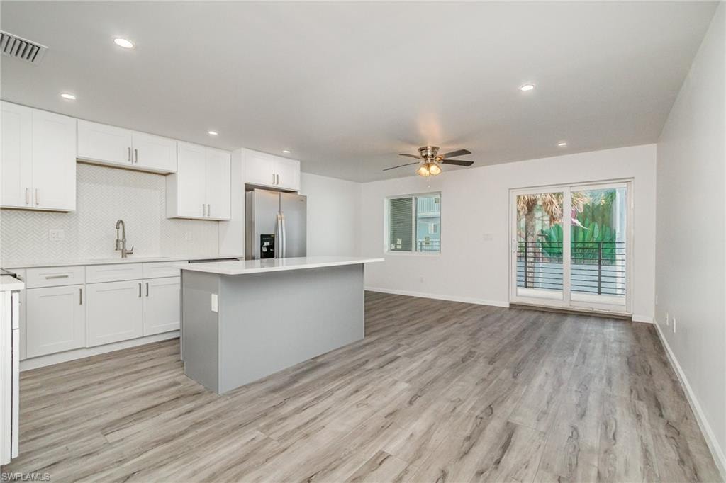Empty room featuring ceiling fan and light wood finished floors