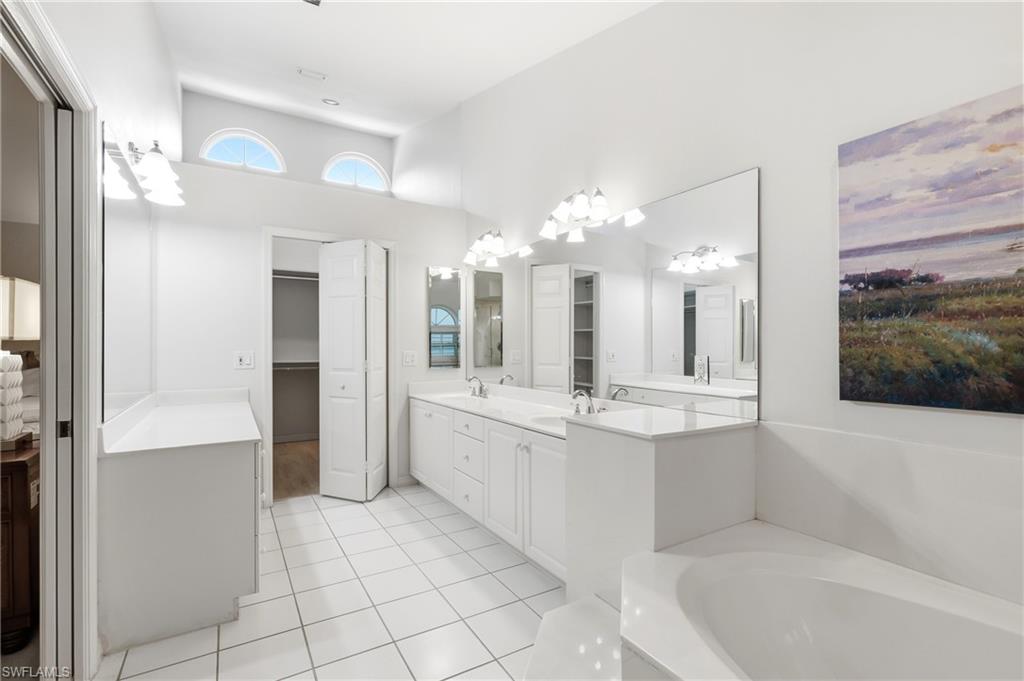 Primary Bath w/ dual vanities leading to Walk-in Closet