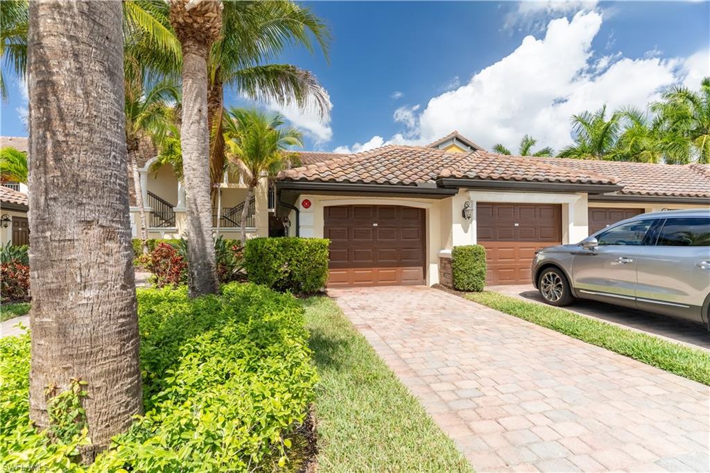 Mediterranean / spanish house featuring stucco siding, a tiled roof, driveway, and an attached garage