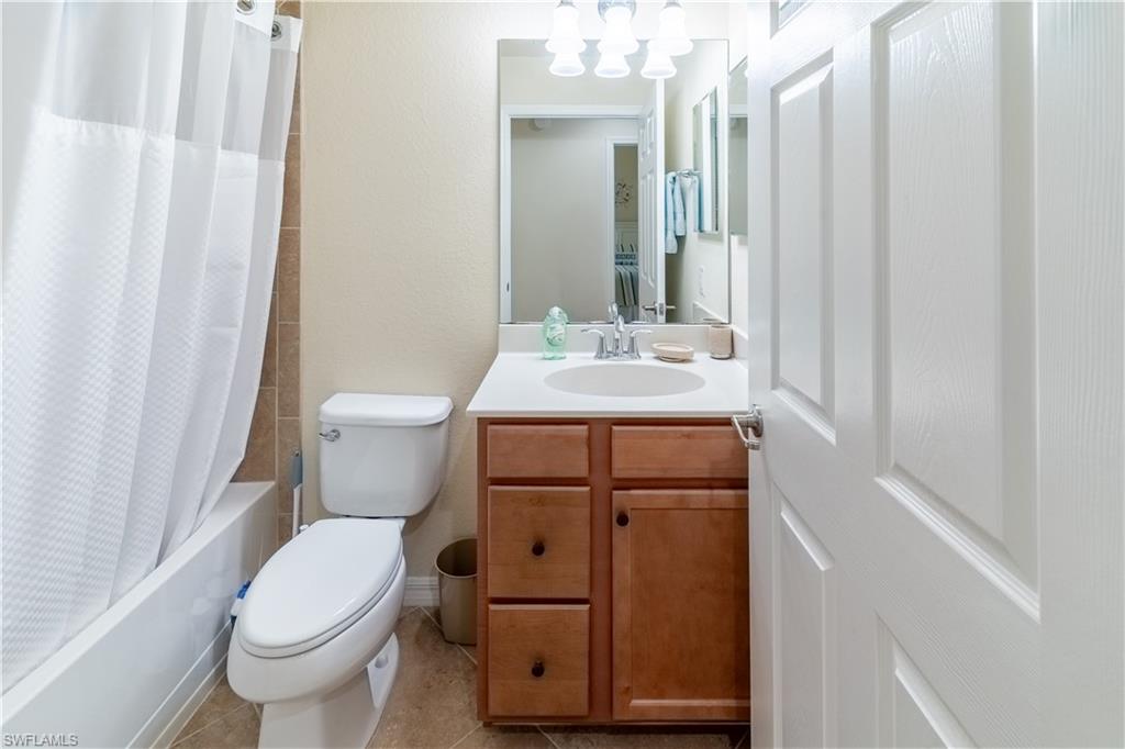 Full bath featuring vanity and shower / tub combo with curtain