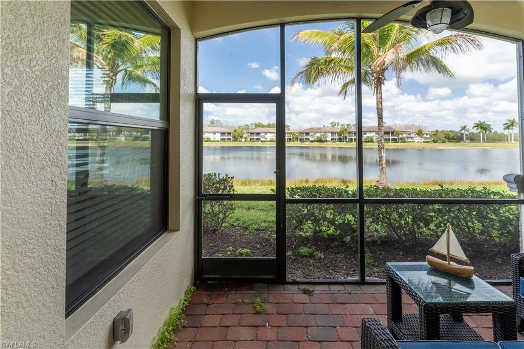 Sunroom / solarium featuring a water view