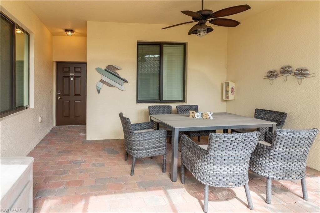 View of patio / terrace with outdoor dining area and a ceiling fan