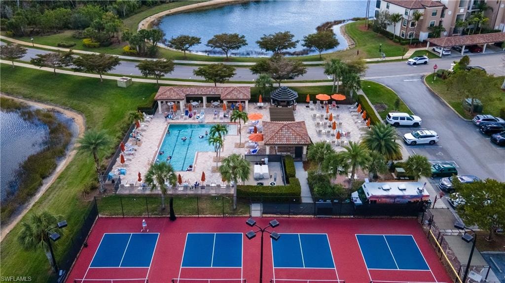 Drone / aerial view of a nearby body of water and a pool