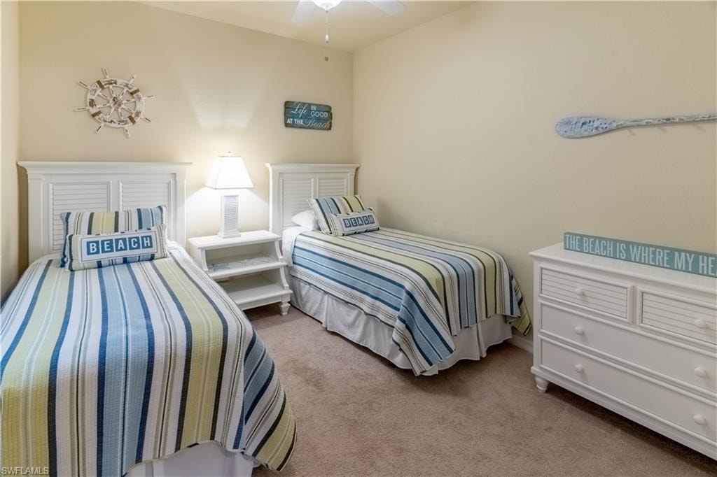 Bedroom featuring light colored carpet and a ceiling fan