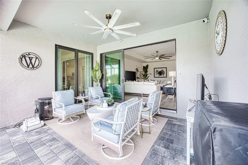 View of patio with an outdoor hangout area and a ceiling fan