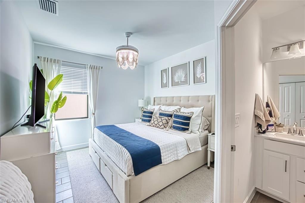 Bedroom featuring baseboards and hanging lights