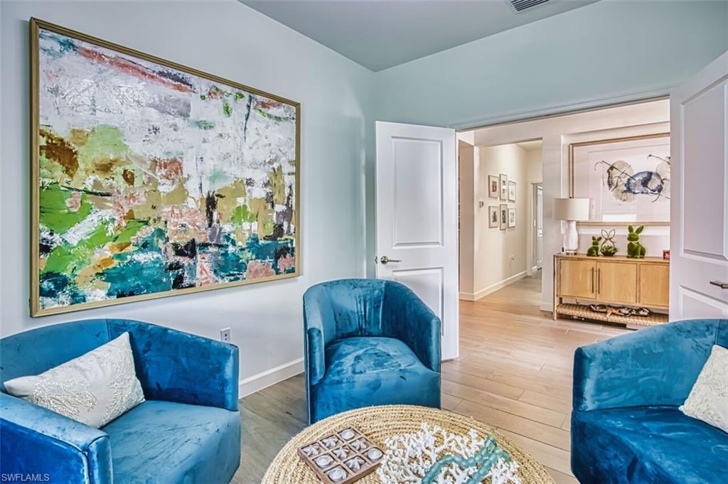 Living area with light wood-style floors and baseboards