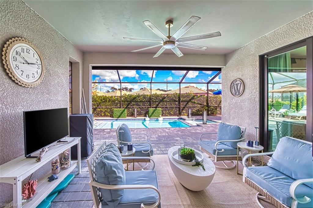 View of patio featuring a sunroom, an outdoor pool, glass enclosure, ceiling fan, and outdoor lounge area