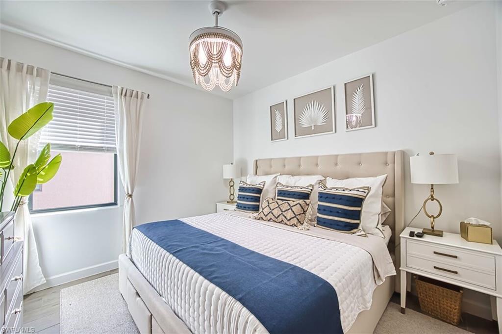 Bedroom with suspended lighting and baseboards