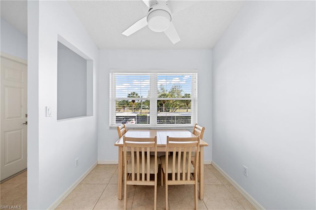 Dining area with light tile patterned floors and a ceiling fan