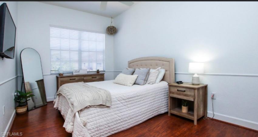 Bedroom featuring dark wood-style floors and a ceiling fan