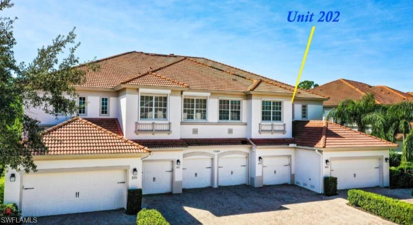 Mediterranean / spanish-style home with a tile roof, stucco siding, driveway, and an attached garage