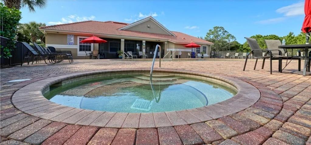 View of pool featuring patio surround and a community hot tub