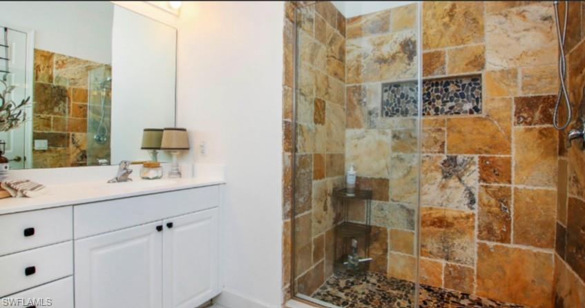 Full bathroom with a shower stall and vanity