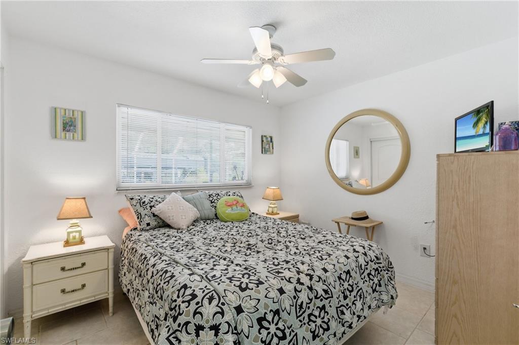 Bedroom with a ceiling fan and light tile patterned floors