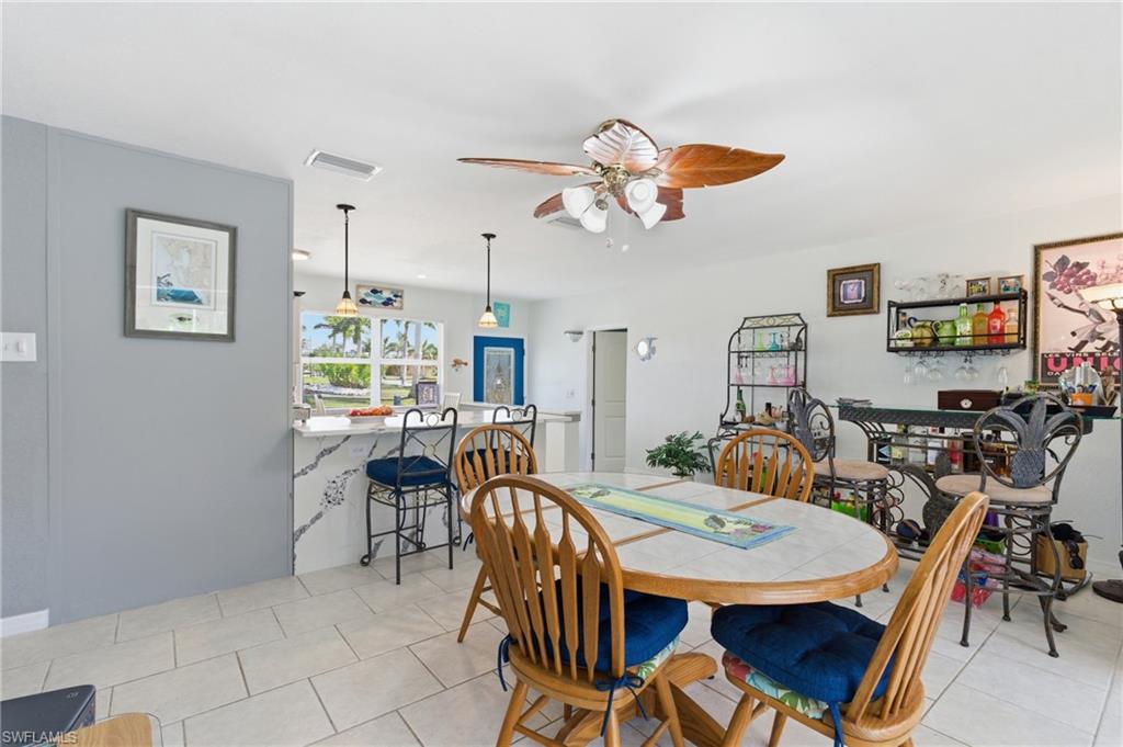 Dining area with a ceiling fan and light tile patterned floors