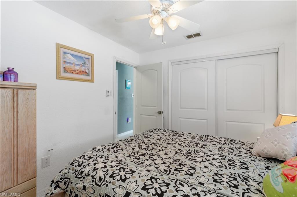 Bedroom with a ceiling fan and a closet