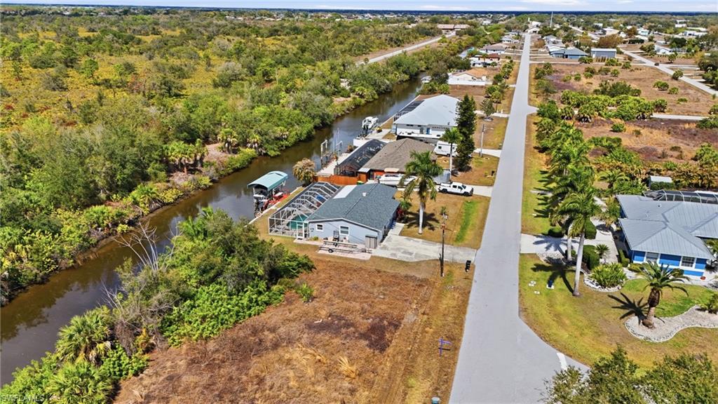 Aerial perspective of suburban area featuring a large body of water