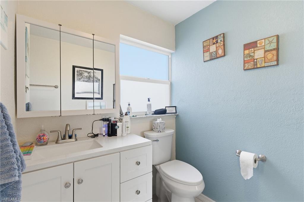 Bathroom featuring vanity and a textured wall