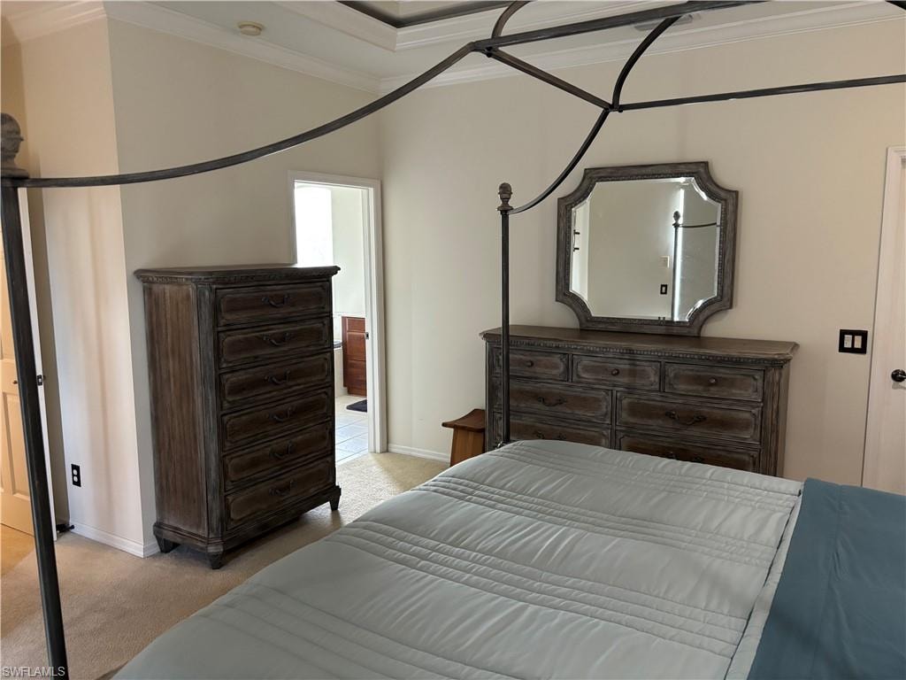 Bedroom featuring light carpet and crown molding