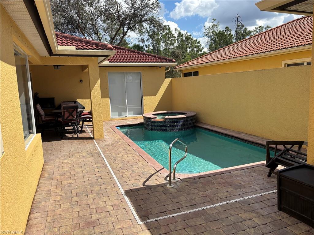 Combined pool / hot tub with a patio