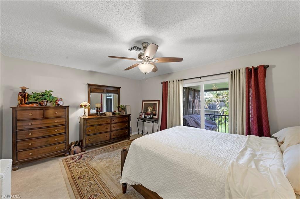 Bedroom featuring access to exterior, ceiling fan, and a textured ceiling