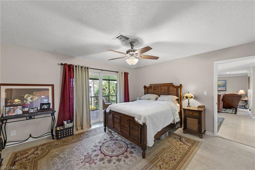 Bedroom featuring access to outside, ceiling fan, and a textured ceiling
