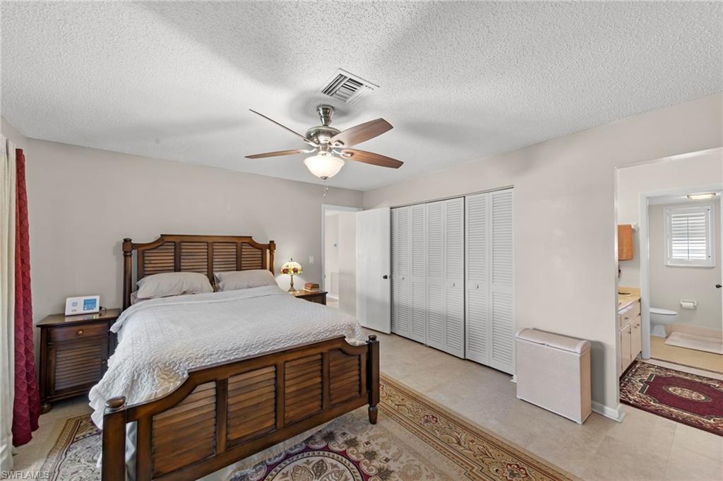 Bedroom featuring a ceiling fan, a textured ceiling, and a closet