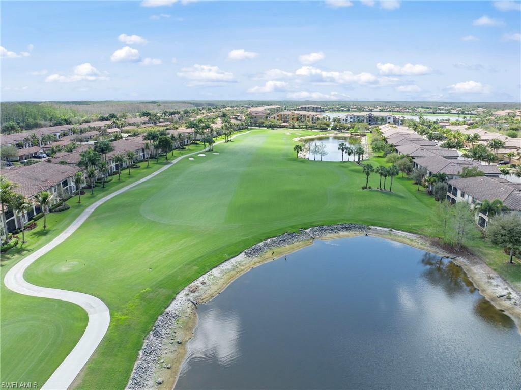 Aerial perspective of suburban area with a nearby body of water and a local golf course