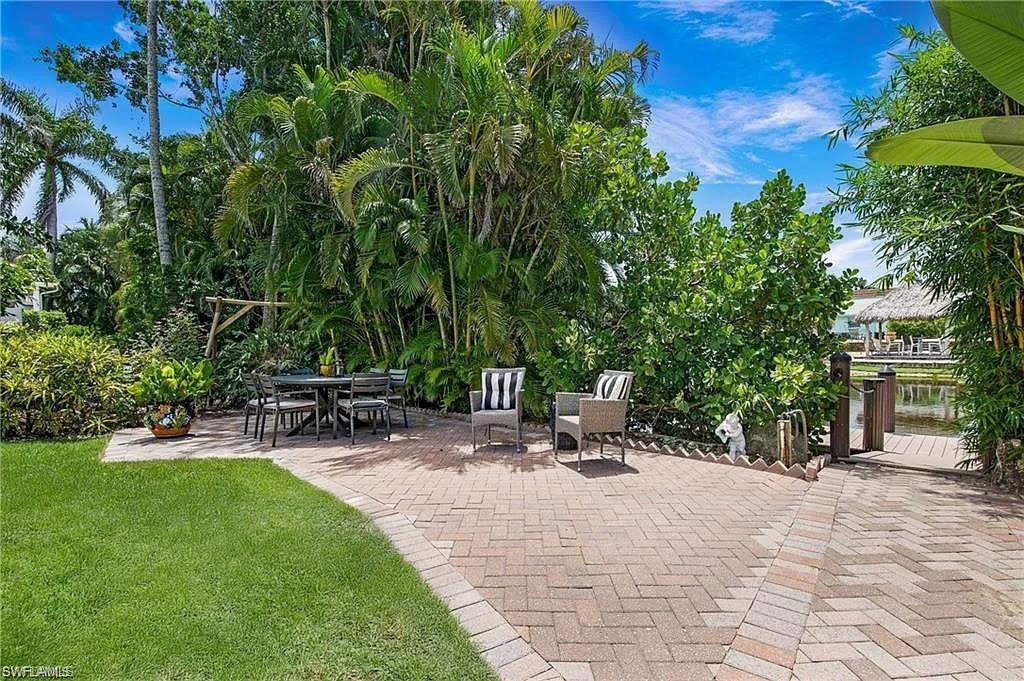 View of community with a patio area and outdoor dining area