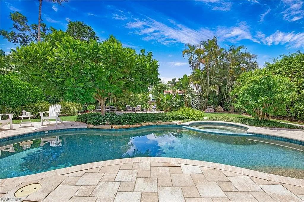 Relaxing pool / spa featuring a patio