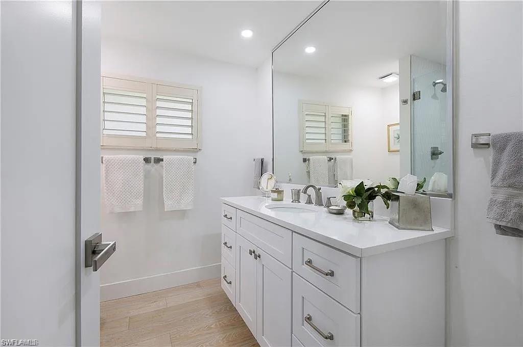 Full bathroom with vanity, light wood-style flooring, and recessed lighting