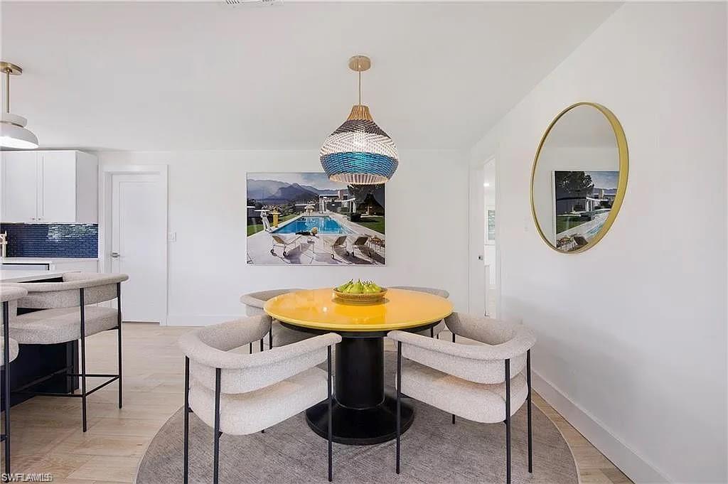 Dining area featuring light wood-style floors and baseboards