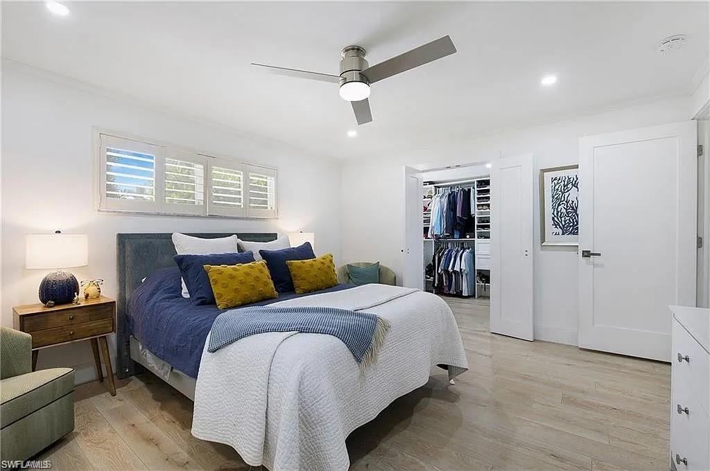 Bedroom with light wood-type flooring, ceiling fan, recessed lighting, and a spacious closet