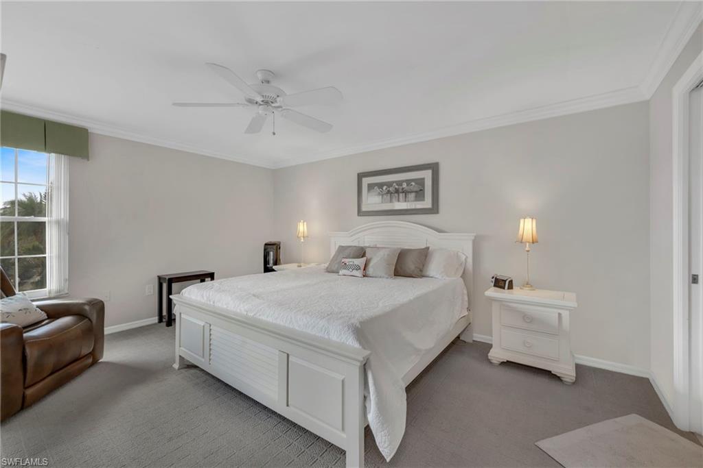 Bedroom with crown molding, carpet, and ceiling fan