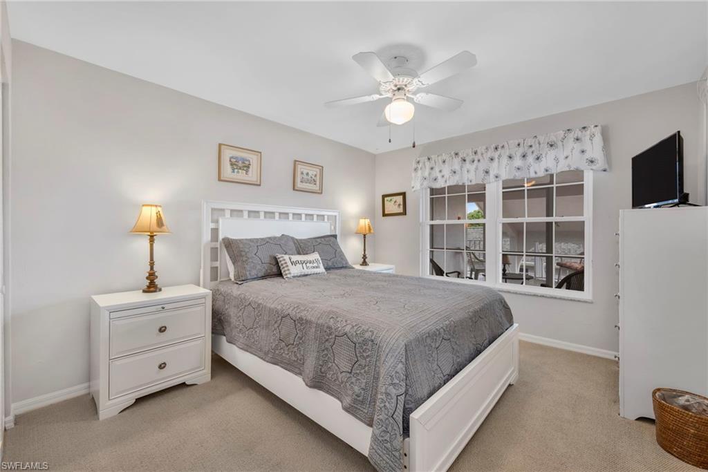 Bedroom with ceiling fan and light colored carpet