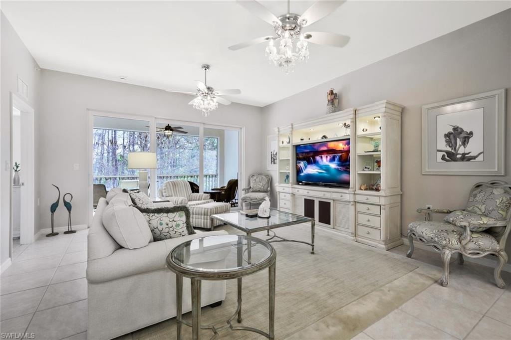 Living room featuring a ceiling fan and light tile patterned floors